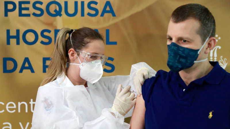 Nurse Isabelli Guasso administers China's Sinovac vaccine, a potential vaccine for the coronavirus disease (COVID-19), to volunteer and doctor Luciano Marini, at the Sao Lucas Hospital of the Pontifical Catholic University of Rio Grande do Sul (PUCRS), in Porto Alegre, Brazil August 8, 2020. REUTERS/Diego Vara