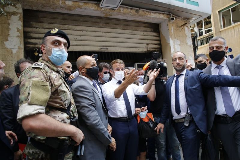 French President Emmanuel Macron gestures as he visits a devastated street of Beirut, Lebanon, Thursday Aug.6, 2020. French President Emmanuel Macron has arrived in Beirut to offer French support to Lebanon after the deadly port blast.(AP Photo/Thibault Camus, Pool)