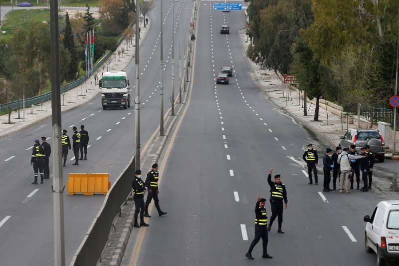 Jordanian police personnel guard at a checkpoint during the second day of a nationwide curfew, amid concerns over the coronavirus disease (COVID-19) spread, in Amman, Jordan March 22, 2020. REUTERS/Muhammad Hamed