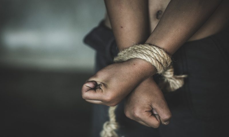 Hands tied up with rope of a missing kidnapped, abused, Violence against children, victim child in pain, human trafficking Concept.