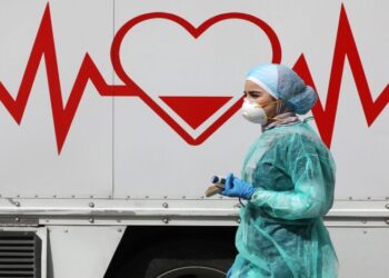 A Jordanian doctor walks next a mobile clinic that is operated as part of initiative that was launched with the aim of providing Jordanians with field medical services, amid concerns over the spread of the coronavirus disease (COVID-19), in Amman, Jordan, March 30, 2020. Picture taken March 30, 2020. REUTERS/Muhammad Hamed - RC2YUF9FKPPE