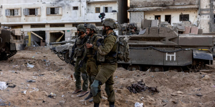 Israeli soldiers stand amid the rubble, during the ongoing ground invasion against Palestinian Islamist group Hamas in the northern Gaza Strip, November 8, 2023. REUTERS/Ronen Zvulun EDITOR’S NOTE: REUTERS PHOTOGRAPHS WERE REVIEWED BY THE IDF AS PART OF THE CONDITIONS OF THE EMBED. NO PHOTOS WERE REMOVED.