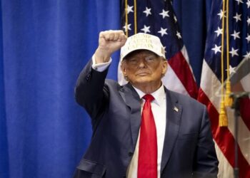 TOPSHOT - Former US President and 2024 Republican presidential hopeful Donald Trump raises his fist at a "Commit to Caucus" event at Simpson College in Indianola, Iowa, on January 14, 2024. (Photo by Christian MONTERROSA / AFP) (Photo by CHRISTIAN MONTERROSA/AFP via Getty Images)