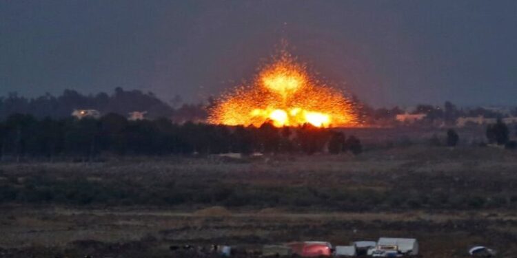 TOPSHOT - A picture taken on July 24, 2018 from the Tal Saki hill in the Israeli-annexed Golan Heights shows an explosion caused by aerial bombardment across the border in Syria, during air strikes backing a Syrian-government-led offensive in the southwestern province of Daraa. (Photo by JALAA MAREY / AFP)        (Photo credit should read JALAA MAREY/AFP via Getty Images)