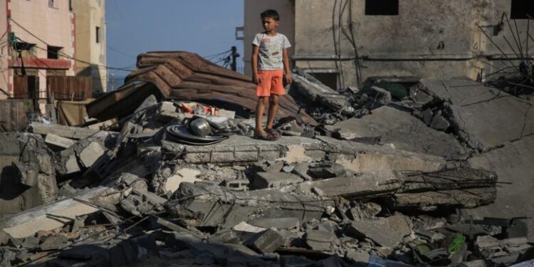 A Palestinian boy inspects damage outside a residential building in Gaza City August 8, 2022, following a cease fire proposed by Egypt between the Israeli army and Palestinian militants. - Israel agreed last night to an Egyptian proposed truce with in Gaza with Islamic Jihad after three days of intense conflict, an Egyptian source said. 
 (Photo by Majdi Fathi/NurPhoto via Getty Images)