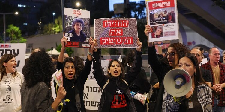 Families of Israeli hostages held by Palestinian militants in the Gaza Strip protest outside the ministry of defence in Tel Aviv calling on November 21, 2023, amid ongoing battles between Israel and the Palestinian armed group. - Israeli Prime Minister Benjamin Netanyahu told his cabinet on November 21 that accepting a deal for the release of hostages taken in the Hamas attacks of October 7 was "a difficult decision but it's a right decision". (Photo by AHMAD GHARABLI / AFP)