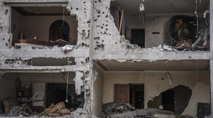 A mural is displayed inside a house destroyed in recent fighting with Israel in Deir al-Balah, central Gaza Strip, Thursday, June 8, 2023. Residents have set up murals and displays of Israeli missiles and fragments in an exhibition aimed at drawing attention to the damage to their homes. Israel attacked hundreds of targets, while Islamic Jihad militants fired over 1,000 rockets into Israel during five days of fighting last month. (AP Photo/Fatima Shbair)
