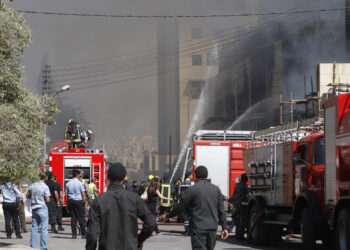 Firefighters extinguish a fire at a wing of a private hospital, which is under construction, in Amman August 5, 2013. Police said an electrical fault caused the massive fire in the Farah Hospital, which sent huge plumes of smoke into the sky and caused traffic to gridlock across Amman as fire engines rushed to the scenes. No casualties were reported but it took civil defence brigades hours to get the fire under control. REUTERS/Majed Jaber (JORDAN - Tags: DISASTER HEALTH)