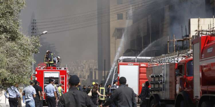 Firefighters extinguish a fire at a wing of a private hospital, which is under construction, in Amman August 5, 2013. Police said an electrical fault caused the massive fire in the Farah Hospital, which sent huge plumes of smoke into the sky and caused traffic to gridlock across Amman as fire engines rushed to the scenes. No casualties were reported but it took civil defence brigades hours to get the fire under control. REUTERS/Majed Jaber (JORDAN - Tags: DISASTER HEALTH)